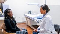 Diagnostic Radiologist discussesbone density scan with patient.